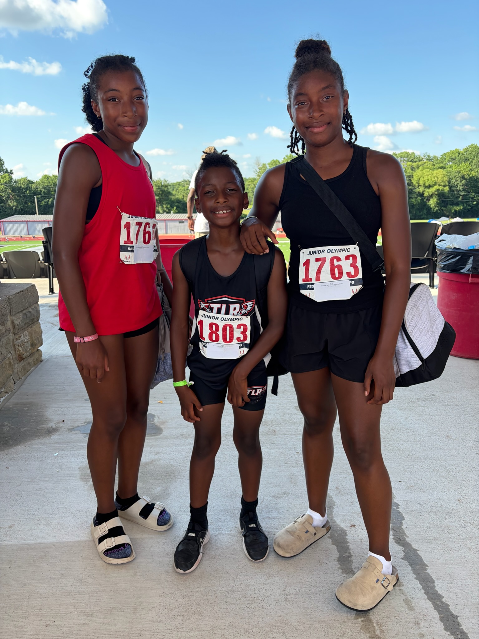 Three TLR athletes together at a Junior Olympic track meet