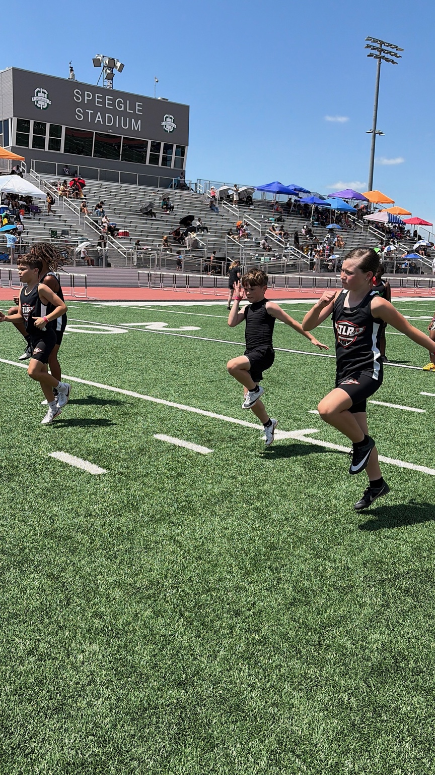 TLR athletes performing dynamic warmups at Speegle Stadium