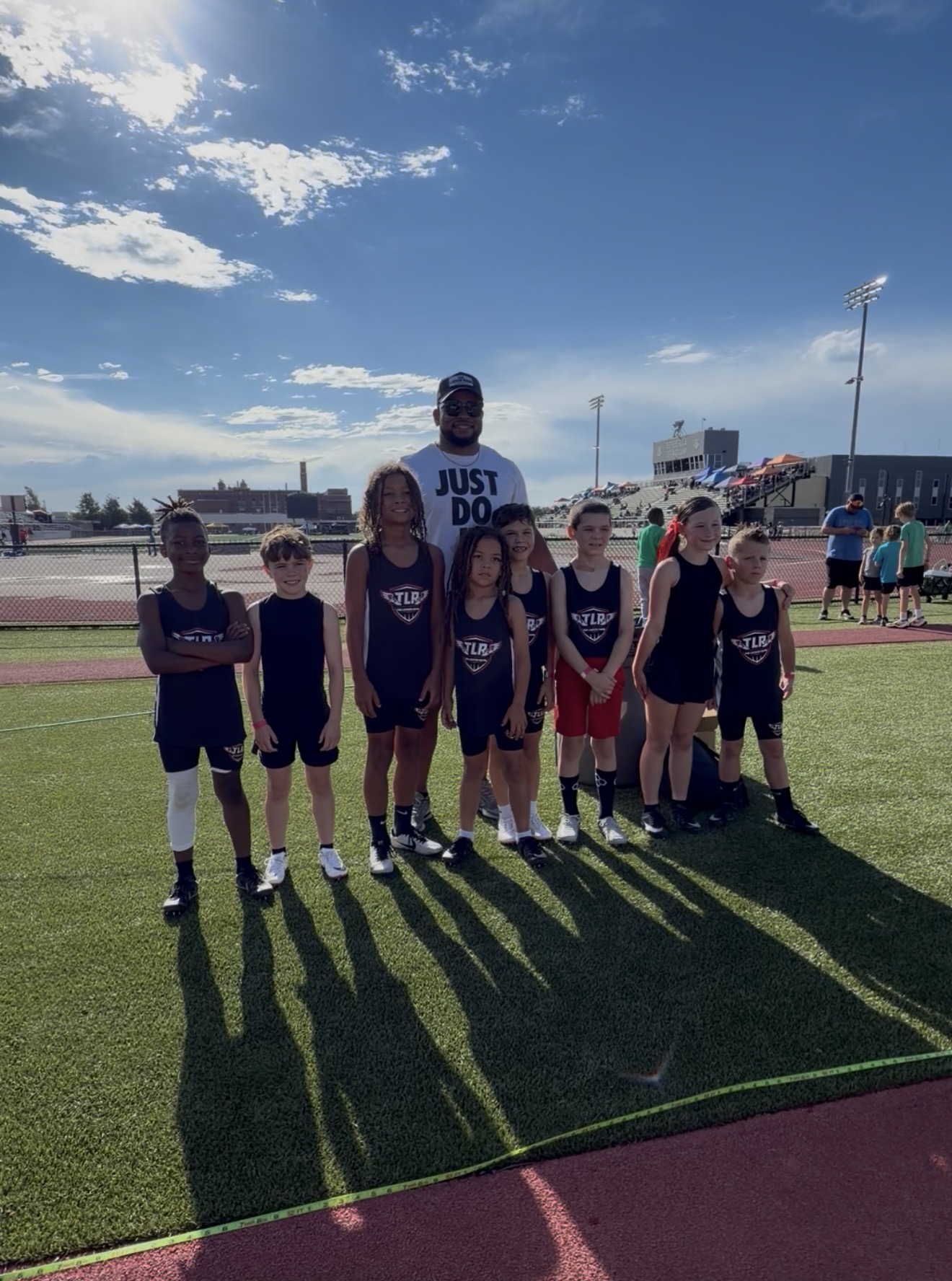 TLR Track athletes and coach together at the track